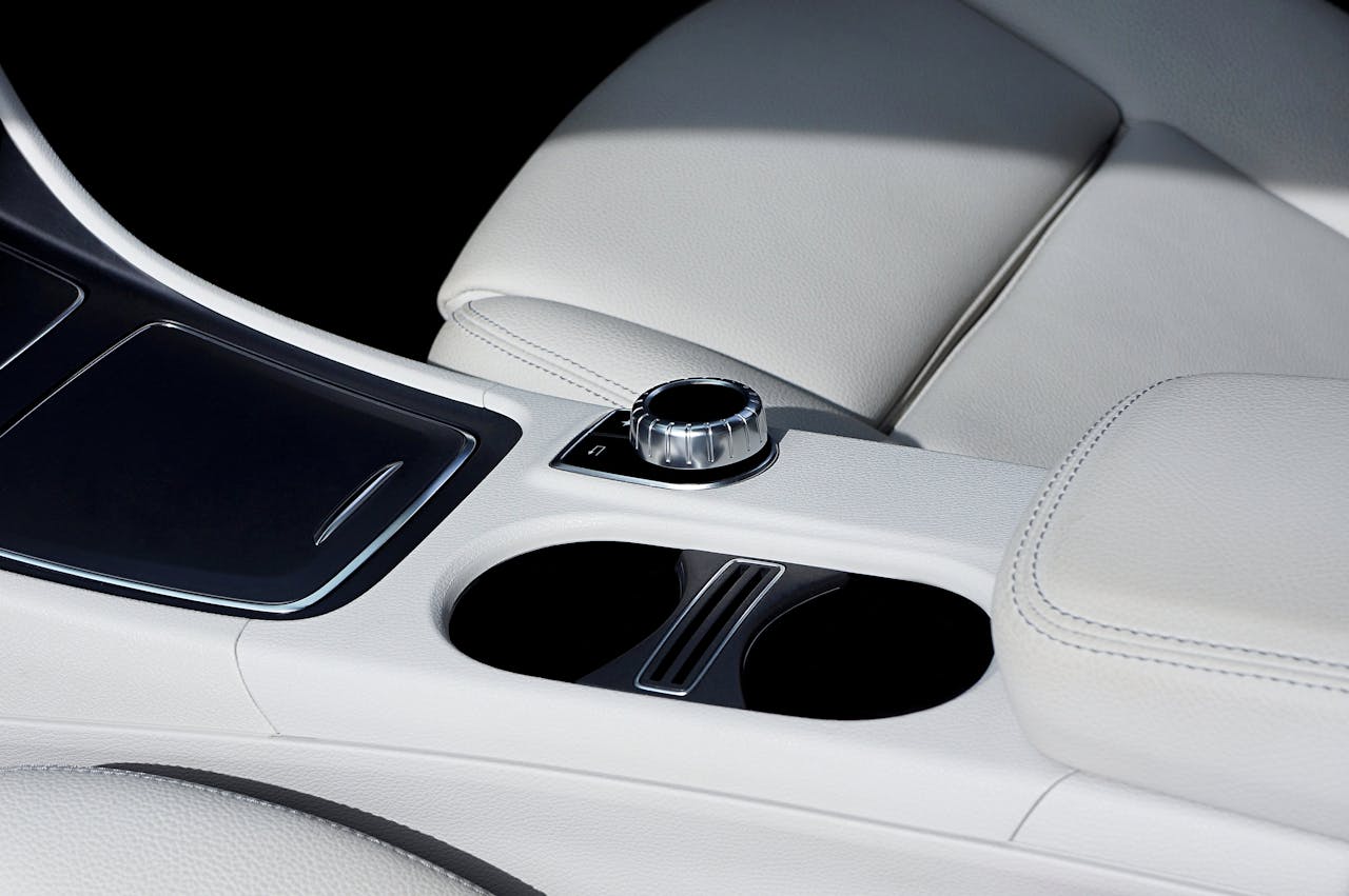hero-img-01 Close-up view of a luxury car interior showcasing elegant leather seats and control panel.