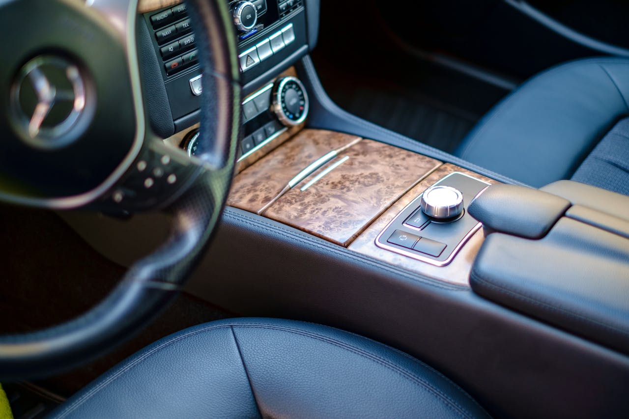 about-01 High-end car interior featuring leather seats and wood accents. Sleek and modern design.