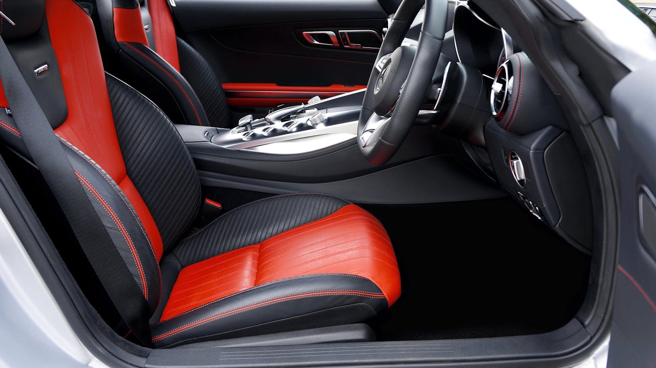 gallery-4 Modern luxury car interior showcasing red and black leather seats, emphasizing style and comfort.