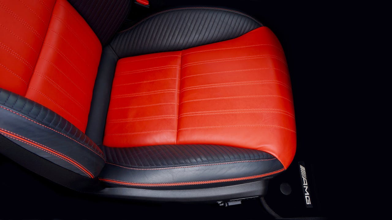gallery-3 Top view of a luxury car seat with red and black leather, emphasizing modern automotive design.